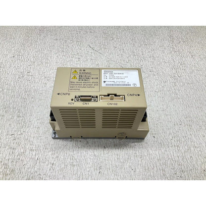 Yaskawa SGDR-SDA140A01B servo drive. Electrical warning label visible on the industrial automation component.