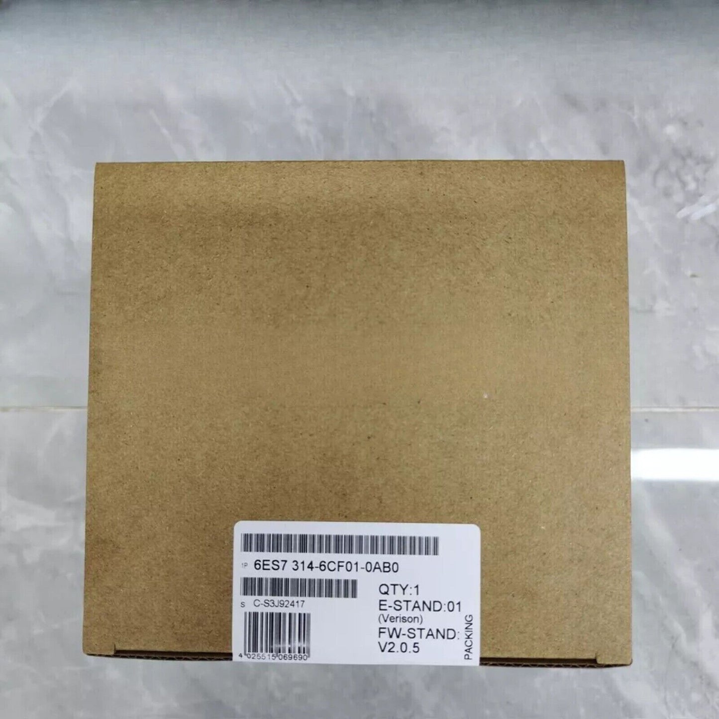 Siemens SIMATIC S7-300 PLC CPU 314C-2DP in brown cardboard box, product details visible.