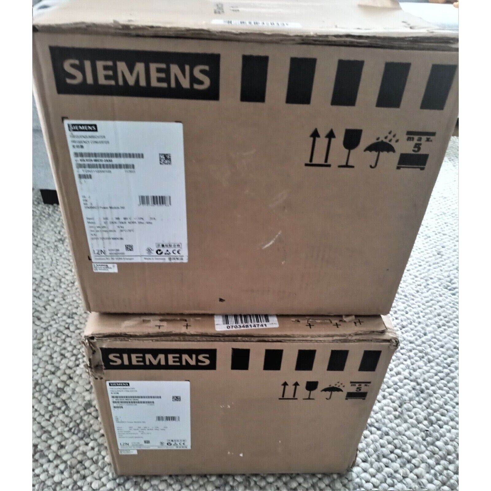 Stacked Siemens SINAMICS G120 PM240 Power Module boxes, industrial automation parts.