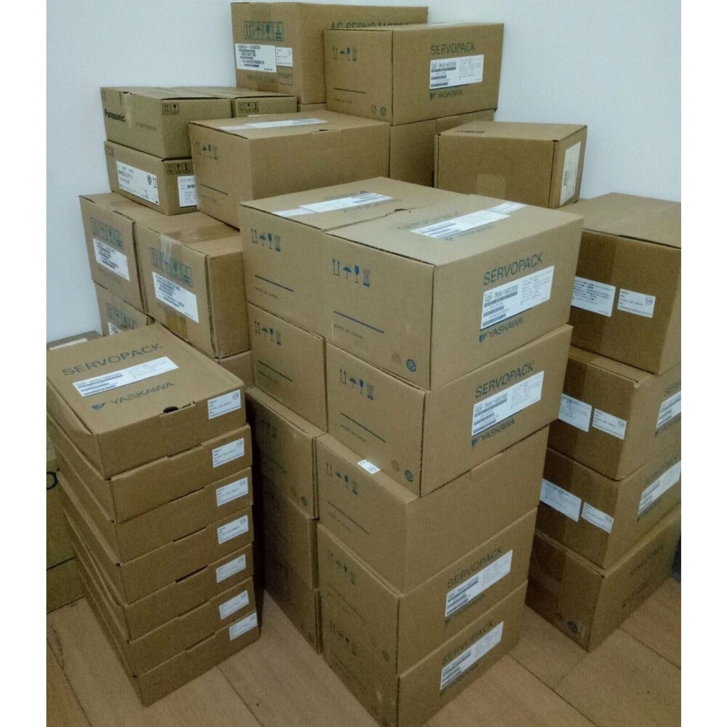 YASKAWA ServoPack boxes stacked, featuring product labels, ideal for industrial automation parts.