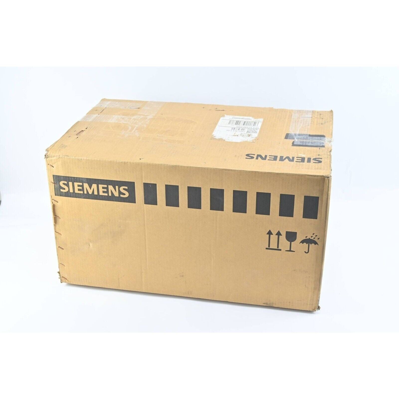 Siemens industrial automation equipment shipping box, cardboard with Siemens logo and handling symbols.
