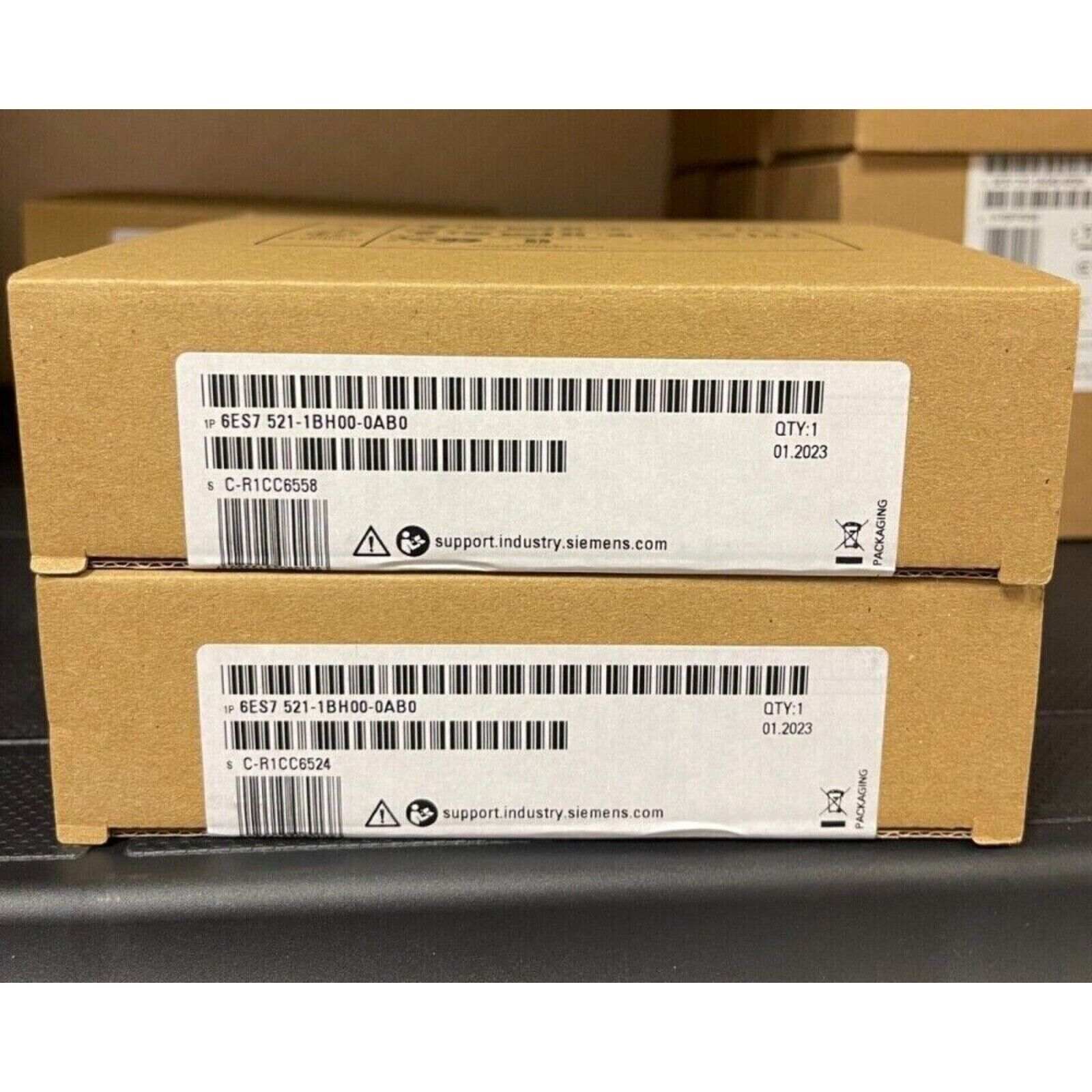 Siemens SIMATIC S7-1500 digital input module boxes, 6ES7 521-1BH00-0AB0, showing product details and packaging.