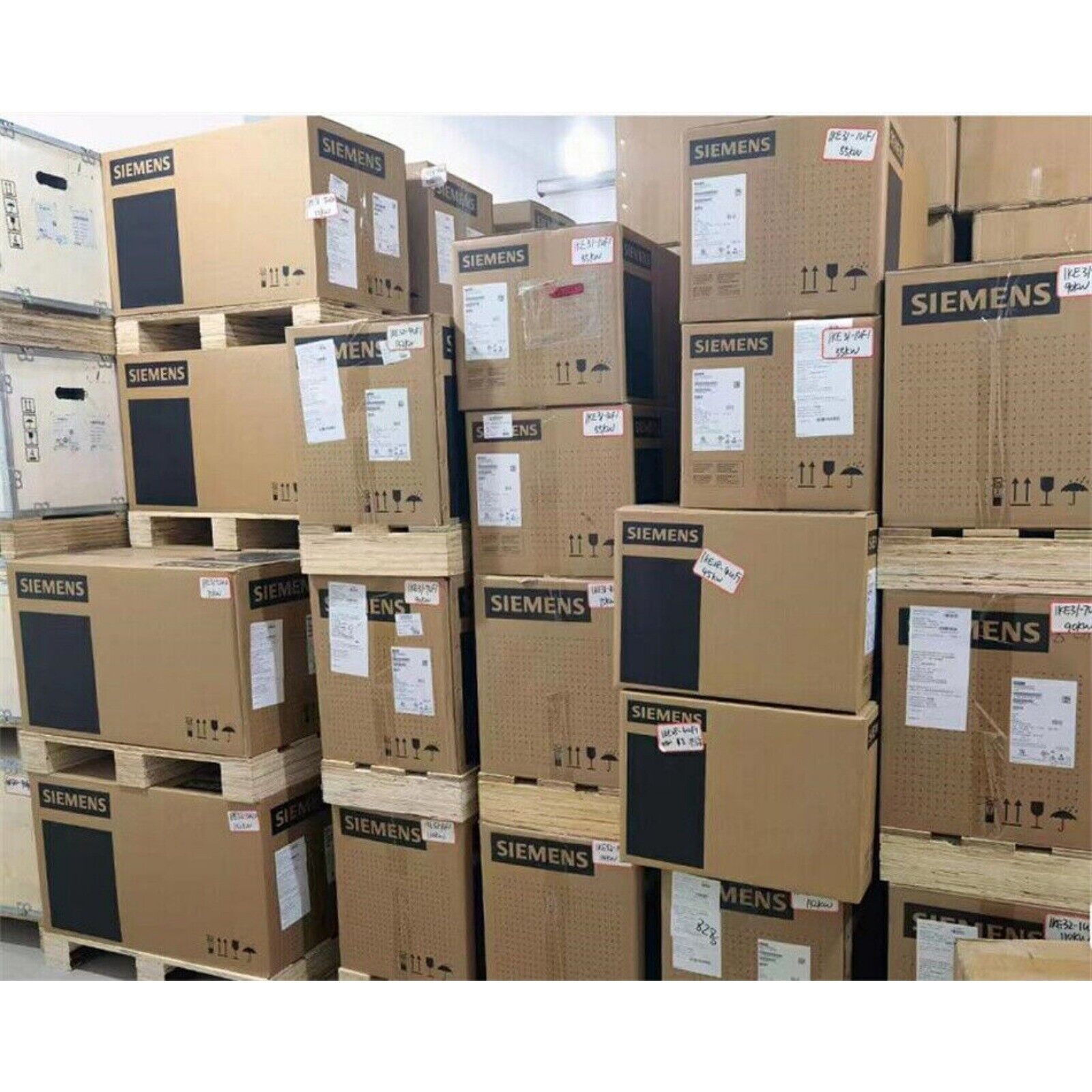 Siemens SINAMICS G120C Power Module boxes stacked on pallets, industrial automation parts inventory