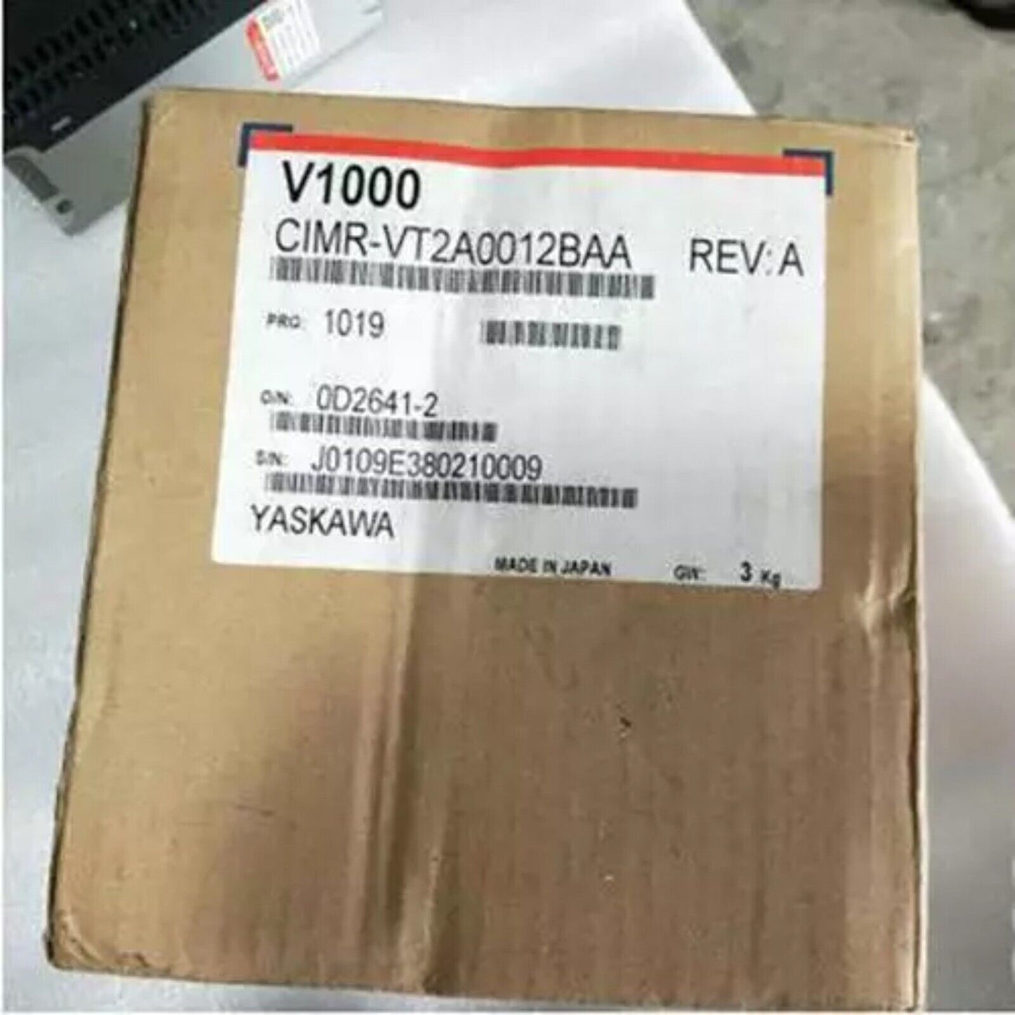 Yaskawa CIMR-VT2A0012BAA V1000 Inverter on a brown cardboard box with product information labels.