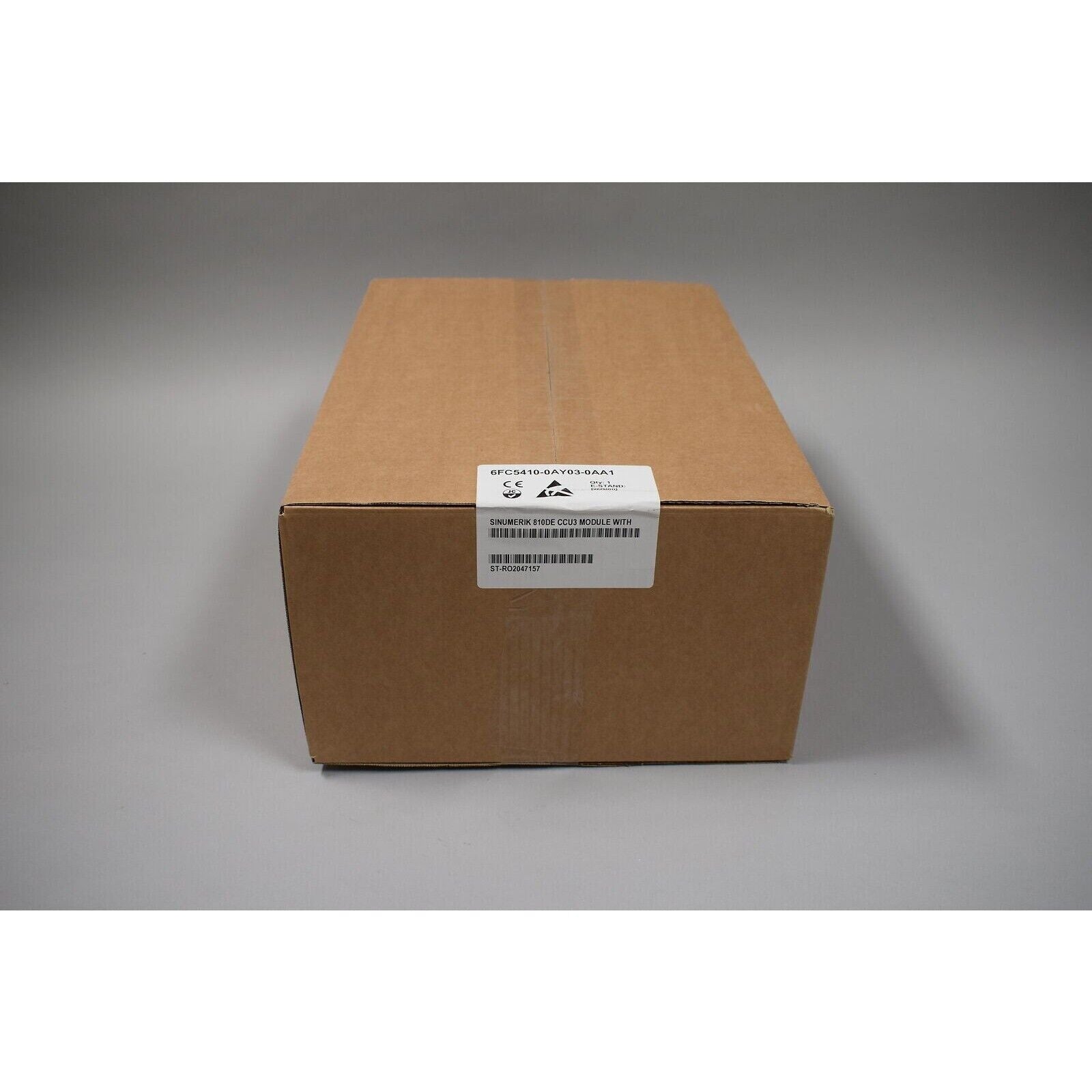 Siemens SINUMERIK 810DE CCU3 module in a cardboard box, industrial automation part.
