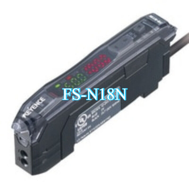 Keyence FS-N18N fiber sensor amplifier. Black housing with clear cover, LED display, and cable.