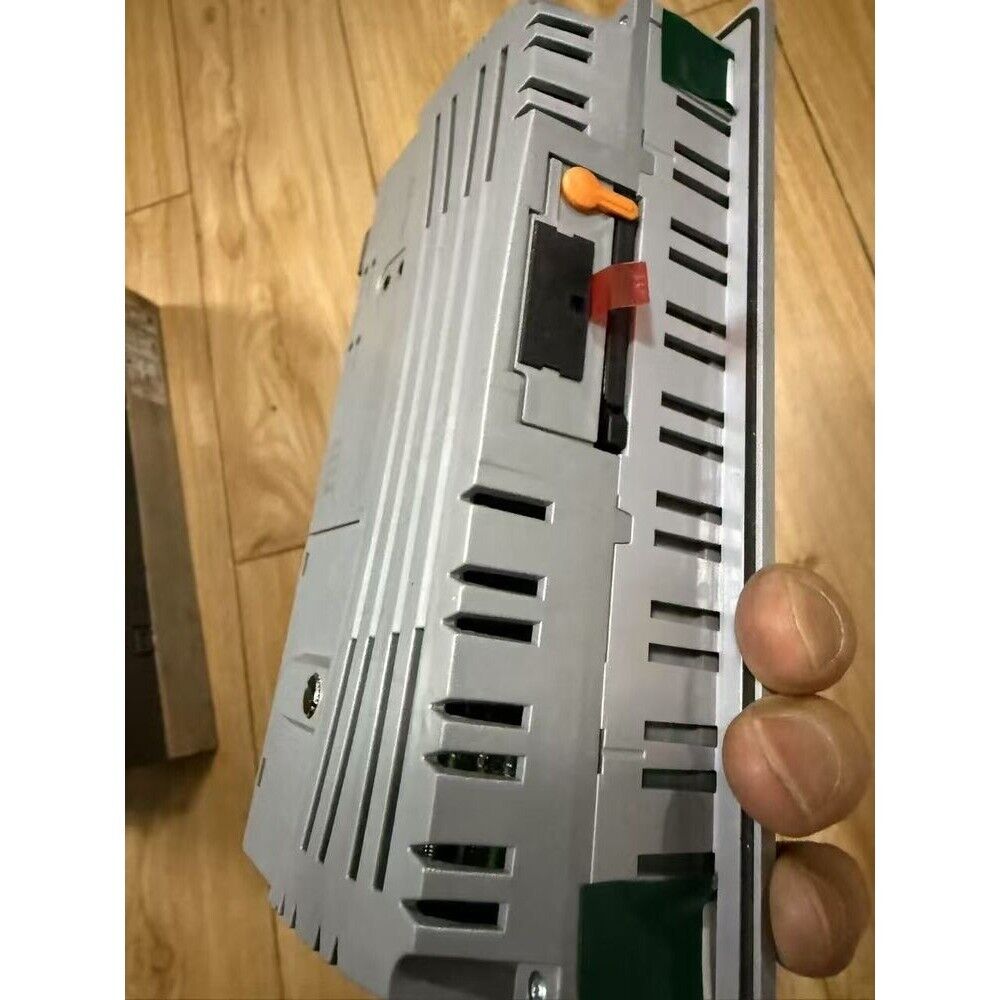 B&R 4PP065.0571-X74F HMI panel side view, silver casing with orange and red connectors, automation equipment.
