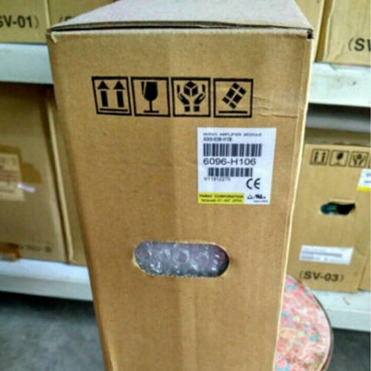 FANUC A06B-6096-H106 Servo Drive in cardboard box, product packaging for industrial automation parts.