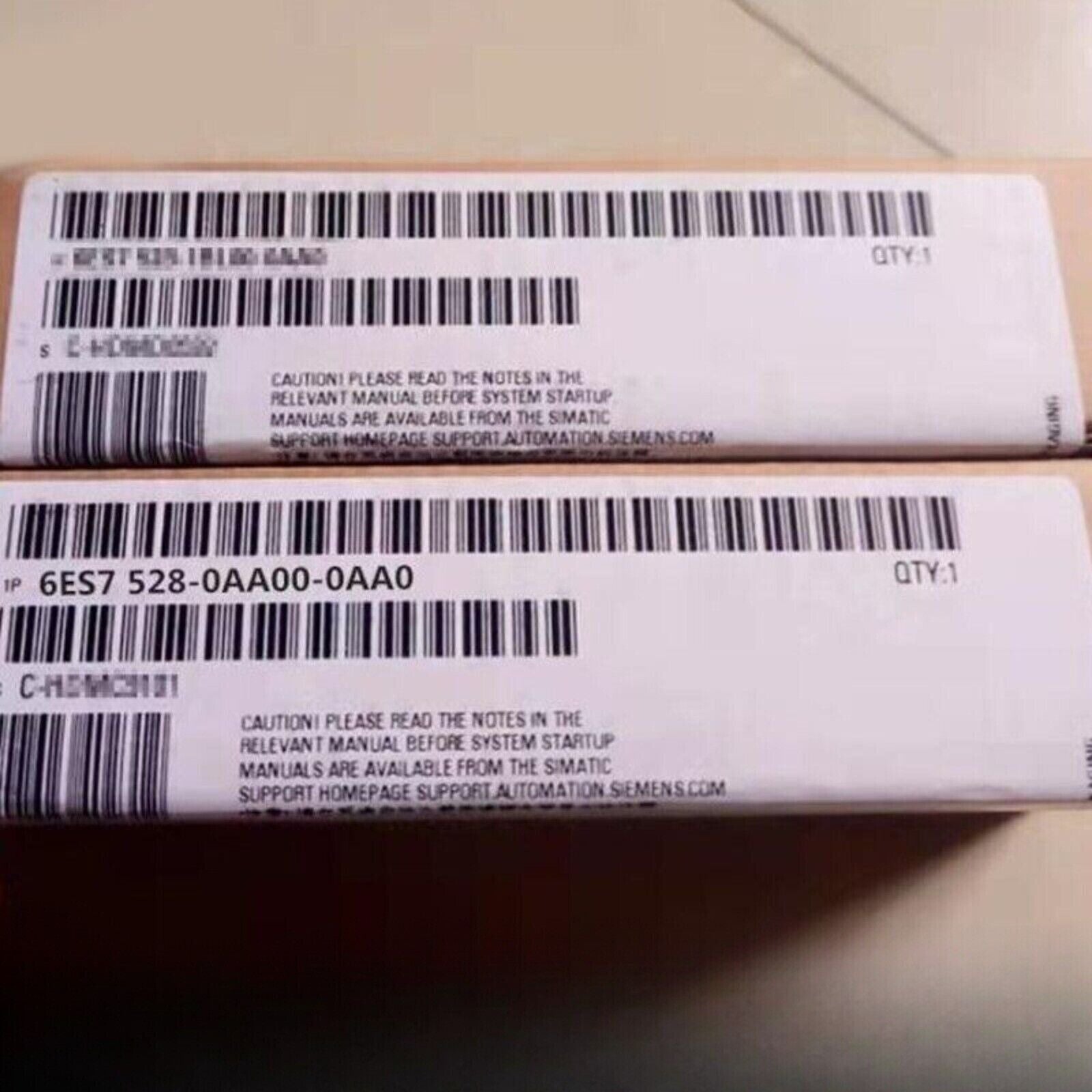 Siemens 6ES7 528-0AA00-0AA0 PLC spare part packaging, product code visible, safety instructions.