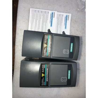 Siemens MICROMASTER 420 industrial drive, black enclosure, automation part, warning labels, and Getting Started manual.