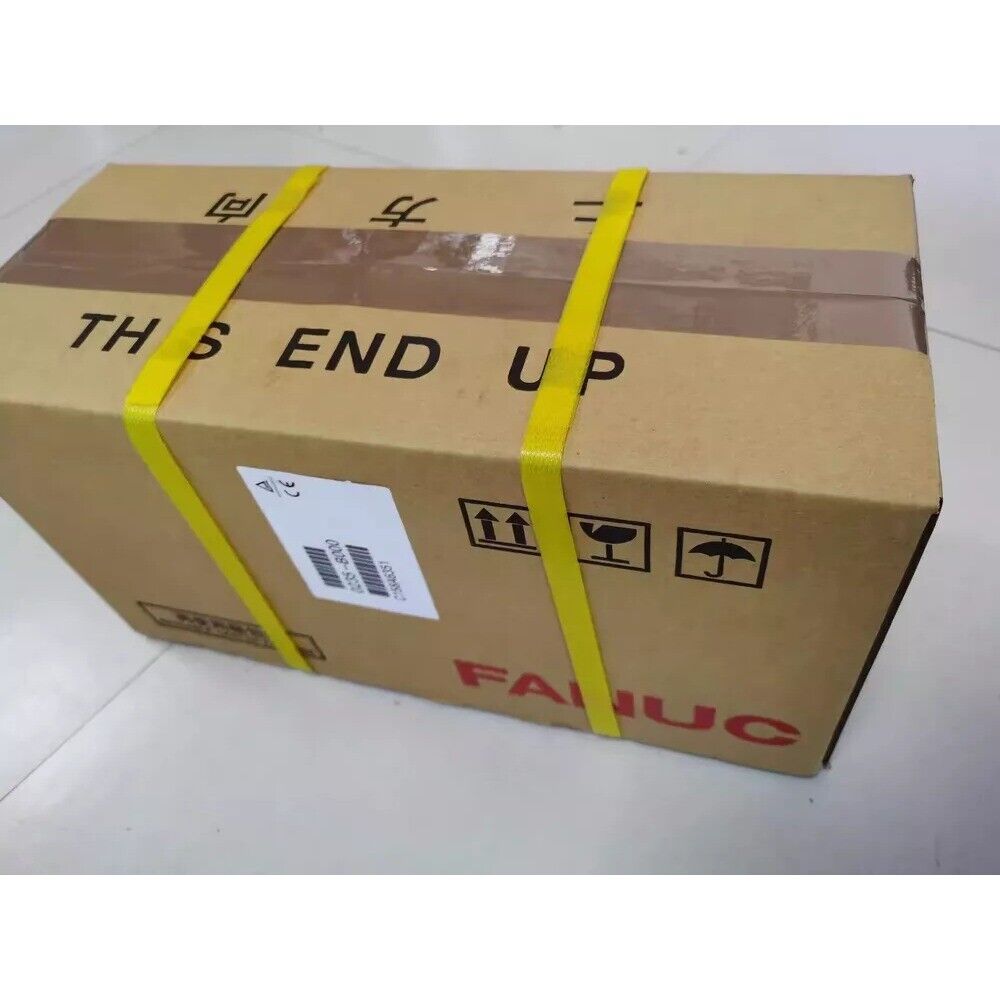 FANUC A06B-0268-B605#S000 servo motor in shipping box. "This End Up" label, yellow straps, new industrial automation part.
