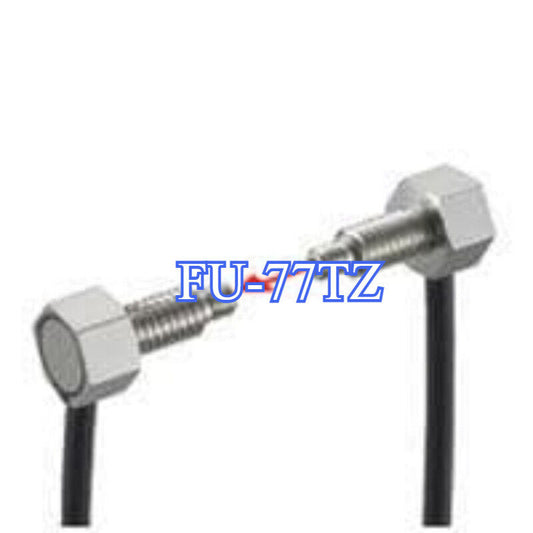 Keyence FU-77TZ transmissive fiber optic sensor unit, industrial automation part with cable and metal body.