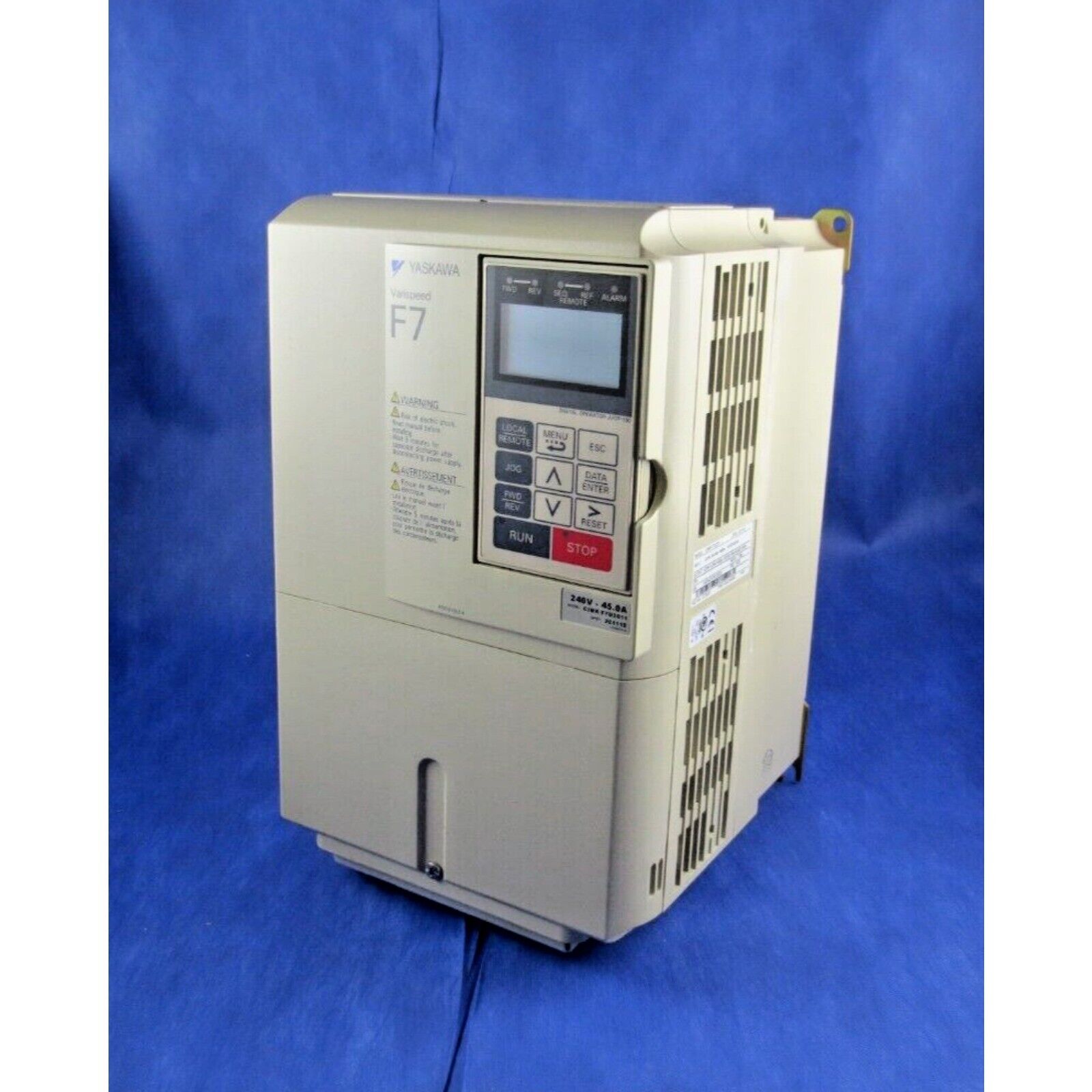 YASKAWA F7 AC Drive. Industrial automation equipment, beige casing, control panel, on blue.