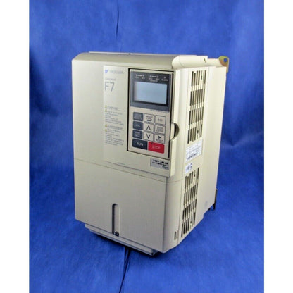 YASKAWA F7 AC Drive. Industrial automation equipment, beige casing, control panel, on blue.