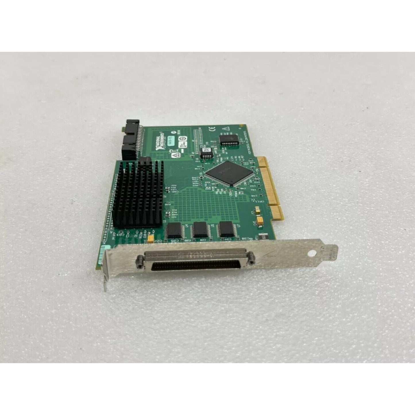 National Instruments PCI-6602 data acquisition card, green circuit board, for industrial automation, with heatsink.