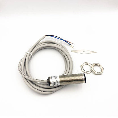 SICK VTE18-4N4212 photoelectric sensor with grey cable, accessories, and mounting hardware. Industrial automation part.