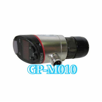 Keyence GP-M010 pressure sensor. Featuring a digital display and black and silver metal body. GP-M010 text is at the bottom.