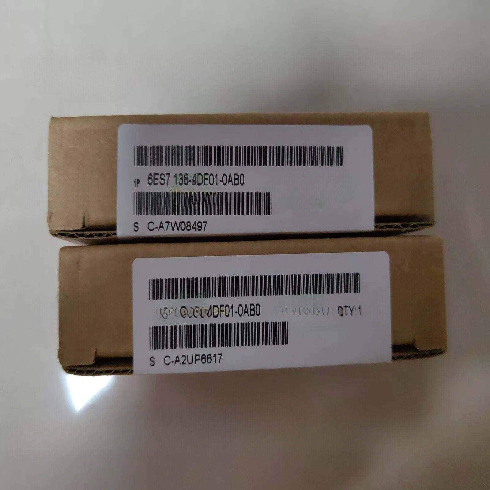 SIMATIC ET 200S PM-E Power Modules in cardboard boxes, with part numbers and bar codes, for industrial automation.