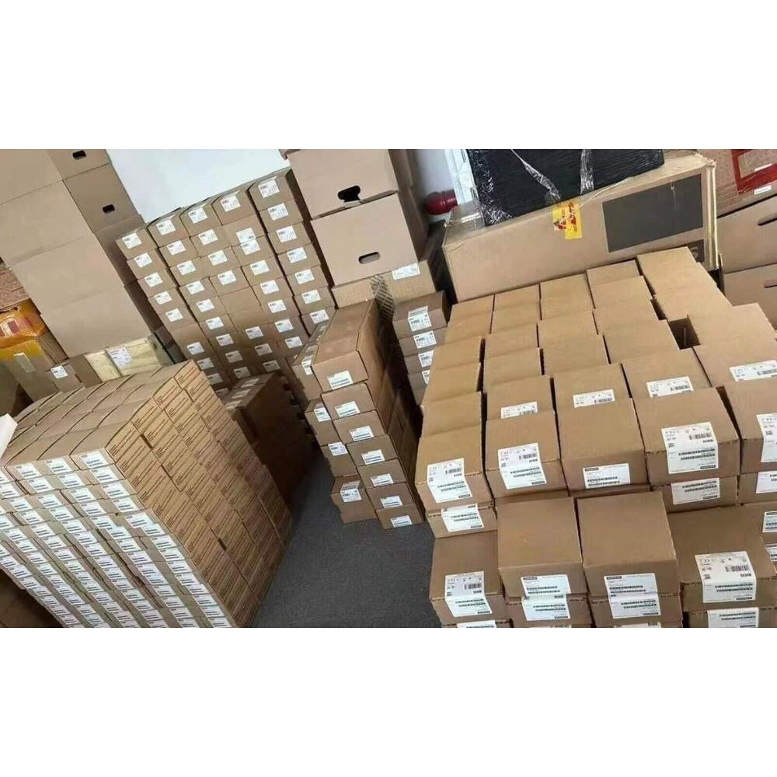 Siemens SINAMICS S120 modules in boxes, ready for shipping. Industrial automation parts.