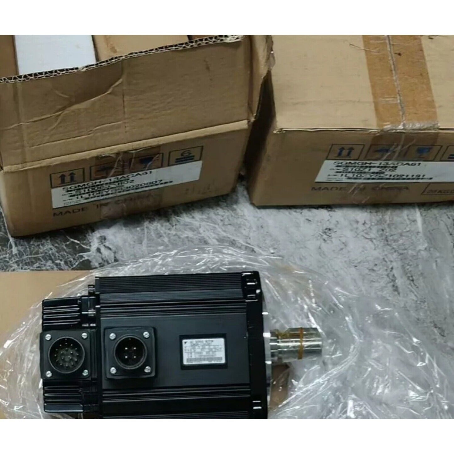 Yaskawa SGMGH-13ACA61 servo motor in box. Black motor with connector. Made in China. Industrial automation spare part.