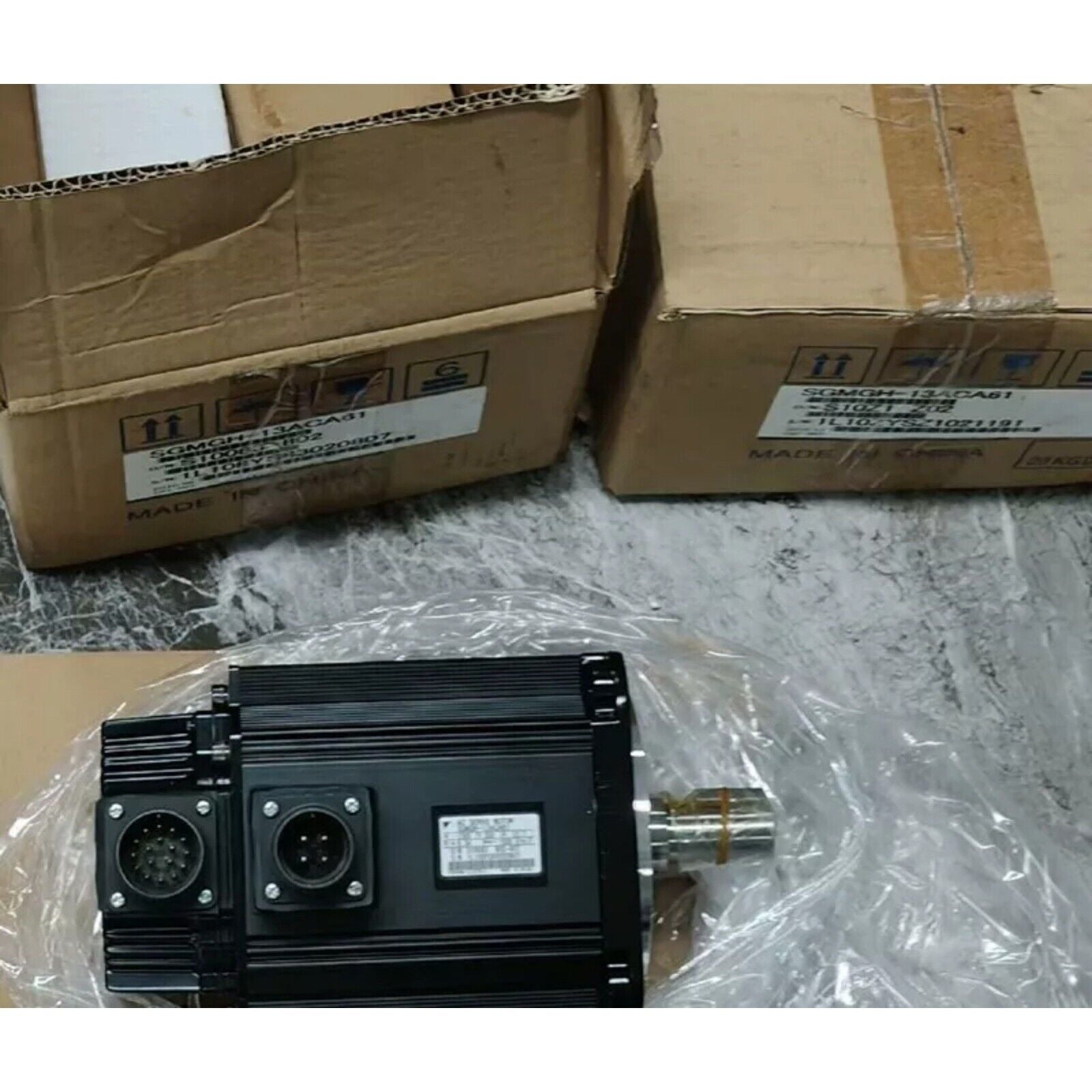 Yaskawa SGMGH-13ACA61 servo motor in box. Black motor with connector. Made in China. Industrial automation spare part.