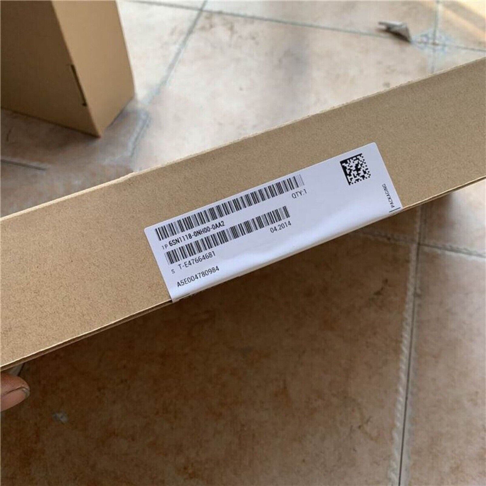 Siemens 6SN1118-0NH00-0AA2 PLC module packaging, with product details label.