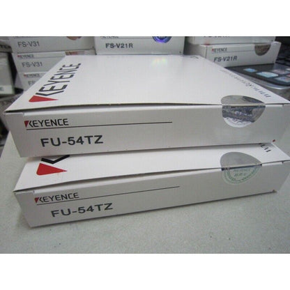 Keyence FU-54TZ fiber amplifier sensor boxes, new in box, featuring the Keyence logo and model number.
