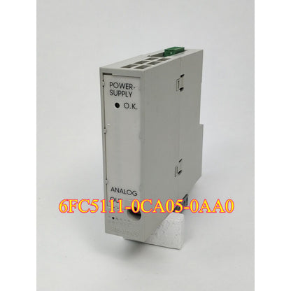 Siemens 6FC5111-0CA05-0AA0 SINUMERIK DMP ANALOG OUT PLC module, industrial automation part, grey with green connectors.