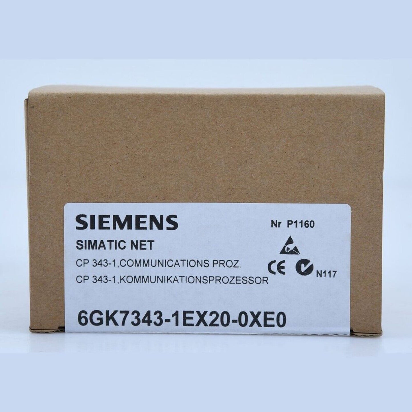 Siemens SIMATIC NET CP 343-1 PLC module 6GK7343-1EX20-0XE0 on a brown cardboard box, industrial automation part.