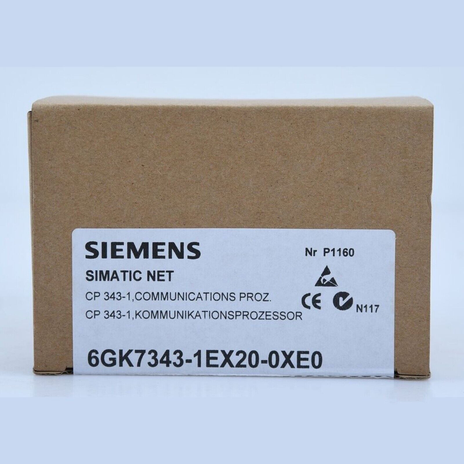 Siemens SIMATIC NET CP 343-1 PLC module 6GK7343-1EX20-0XE0 on a brown cardboard box, industrial automation part.