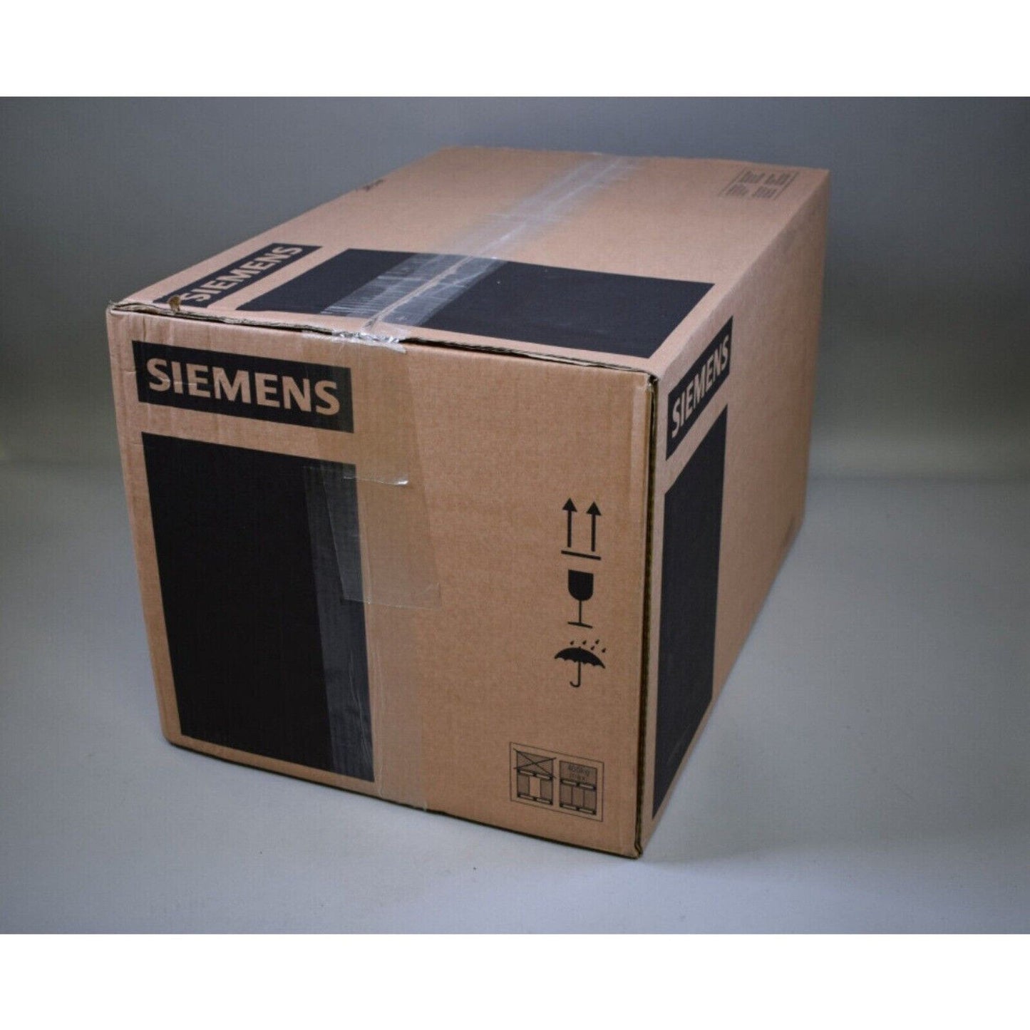 Siemens PLC module packaging, industrial automation equipment box.