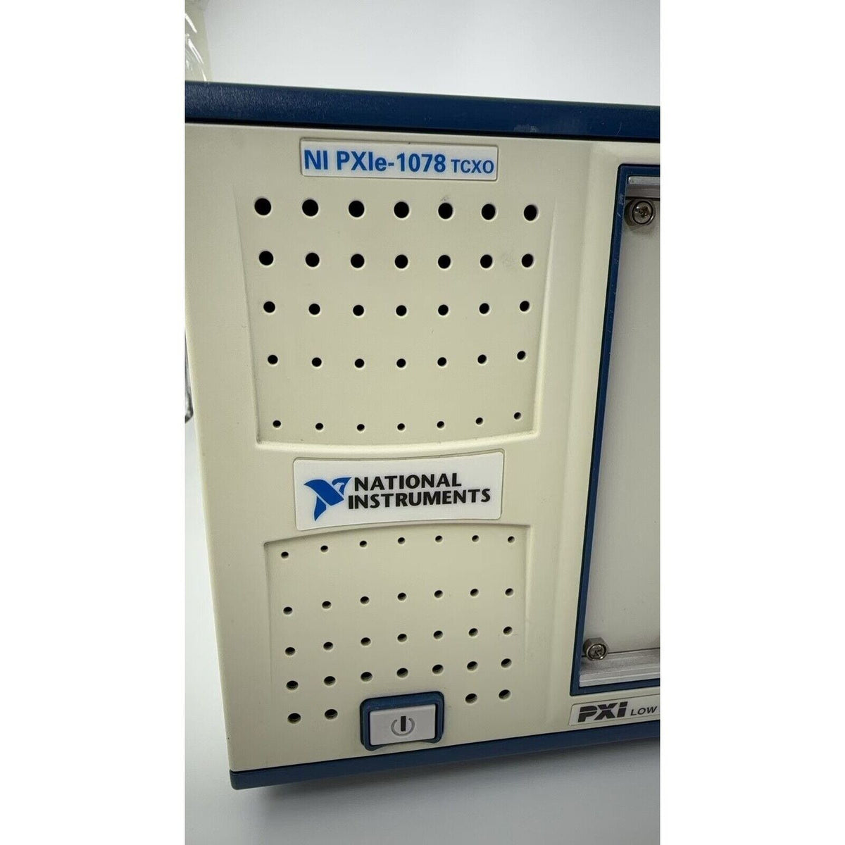 National Instruments PXIe-1078 TCXO PXI Chassis. Beige, blue industrial automation equipment with logo and PXI Low label.