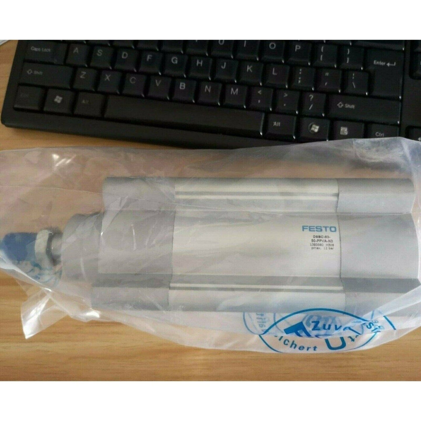 Festo DSBC-63-50-PPVA-N3 ISO cylinder. Silver pneumatic cylinder in a plastic bag.