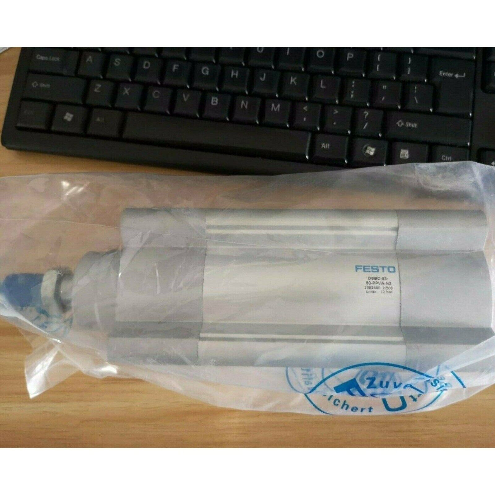 Festo DSBC-63-50-PPVA-N3 ISO cylinder. Silver pneumatic cylinder in a plastic bag.