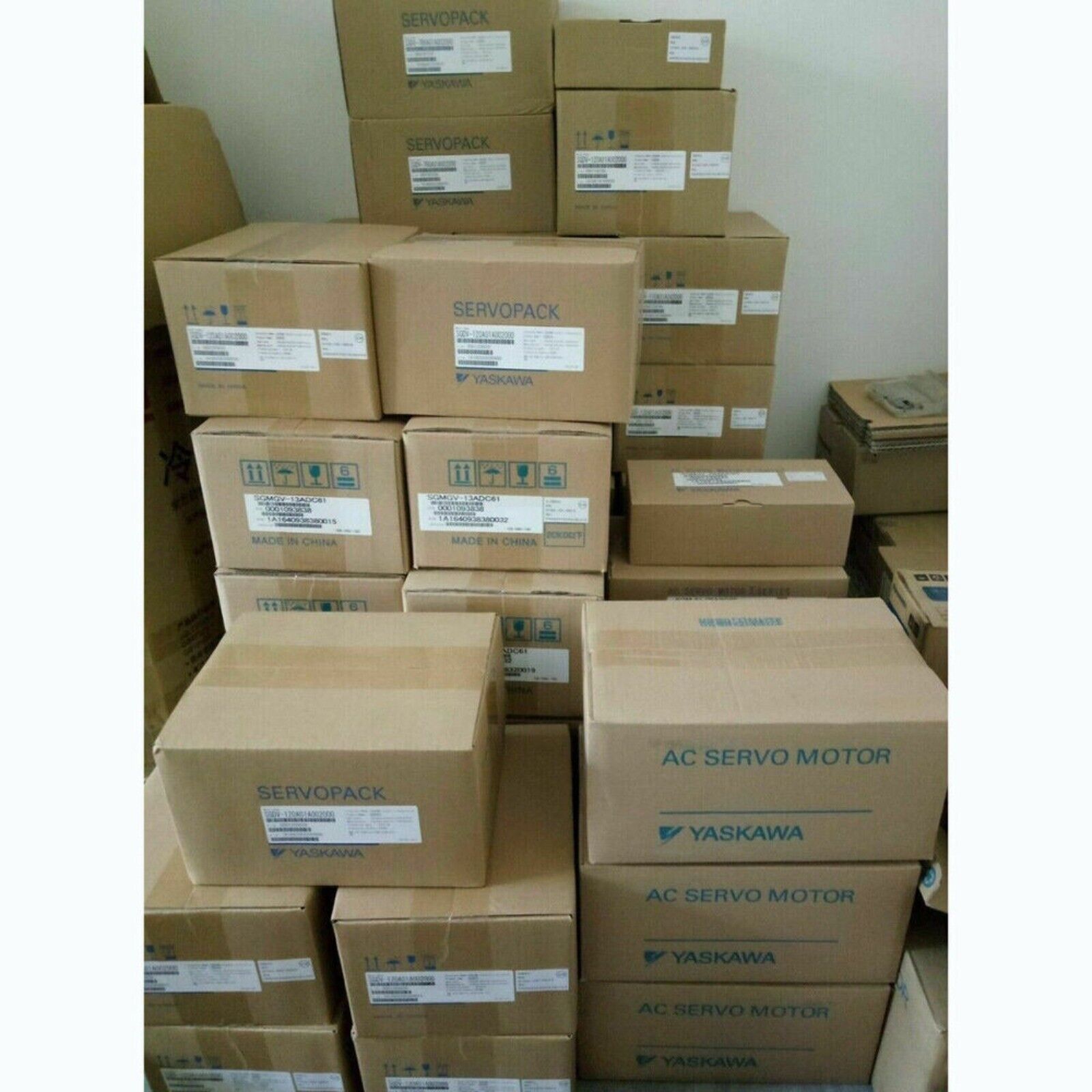 Yaskawa AC Servo Motors in boxes. Industrial automation components, servo drives.