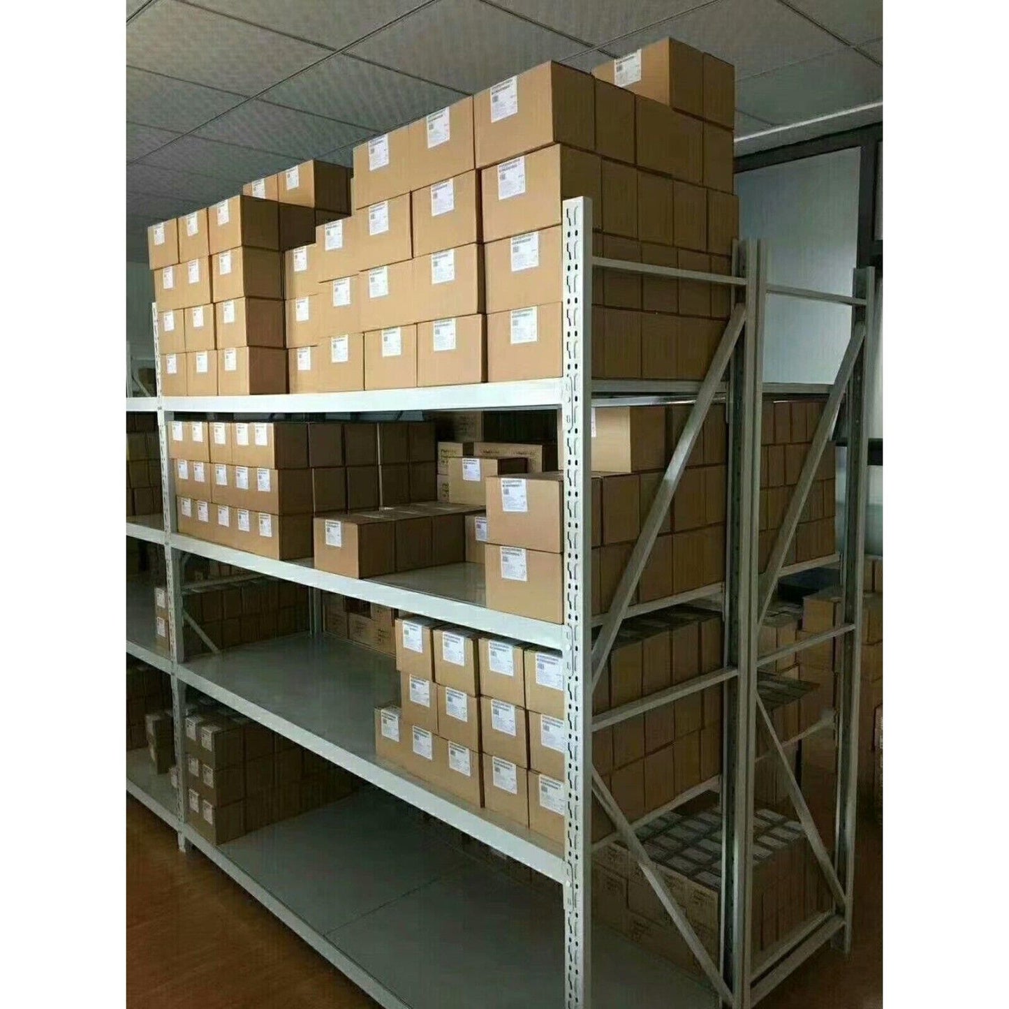 Warehouse storage of industrial automation parts including MICROMASTER 420 frequency inverters, ready for shipment.