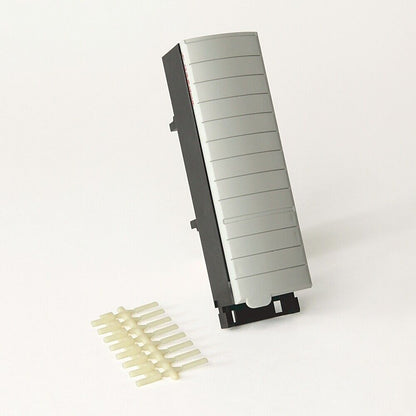 Allen-Bradley 1756-TBSH PLC module with gray face and cream-colored pins. Industrial automation component.