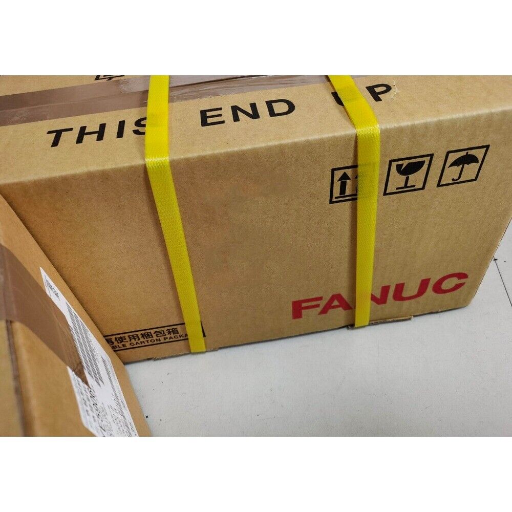FANUC product shipping box, cardboard packaging with yellow straps and handling instructions