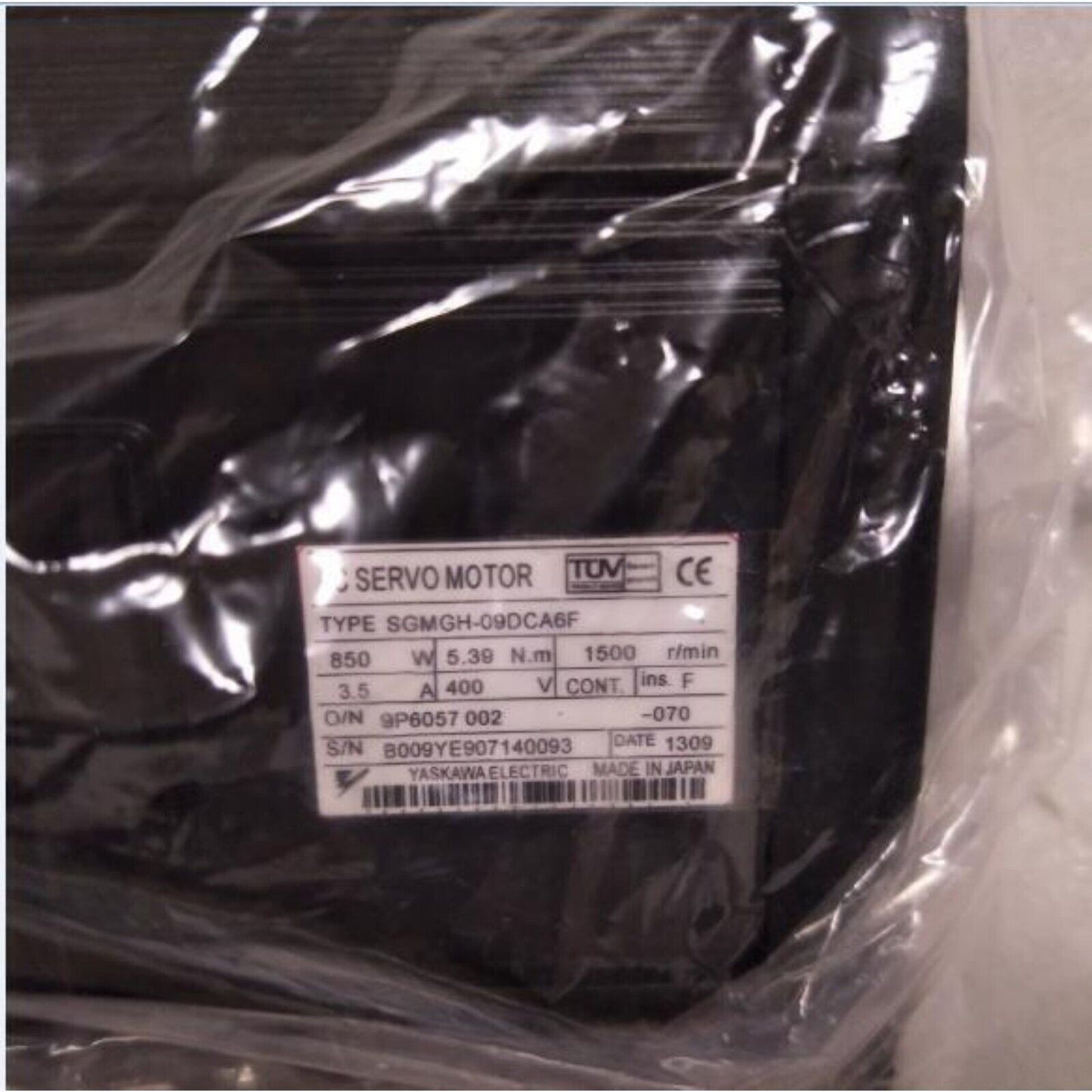 YASKAWA SGMGH-09DCA6F AC servo motor label, Made in Japan, product details visible through plastic packaging.
