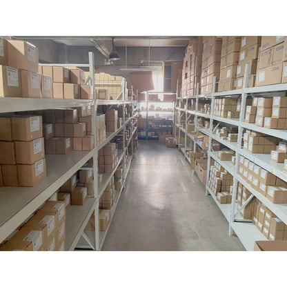 Warehouse storage, industrial automation parts. Boxes on shelves, possibly Siemens HMI panels.