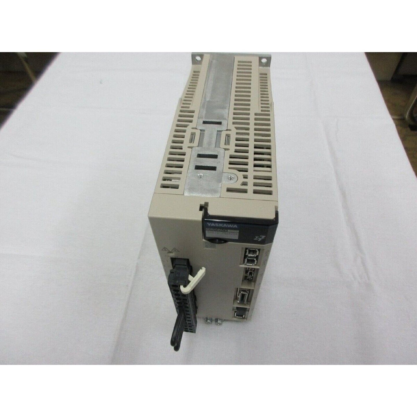 Yaskawa SGD7S-7R6A20A Servopack servo drive, unused spare part. Beige housing and industrial automation components.