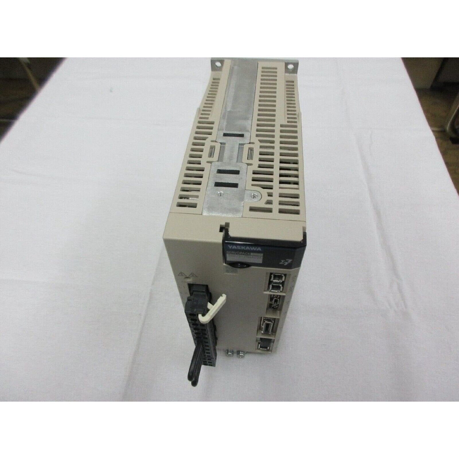 Yaskawa SGD7S-7R6A20A Servopack servo drive, unused spare part. Beige housing and industrial automation components.