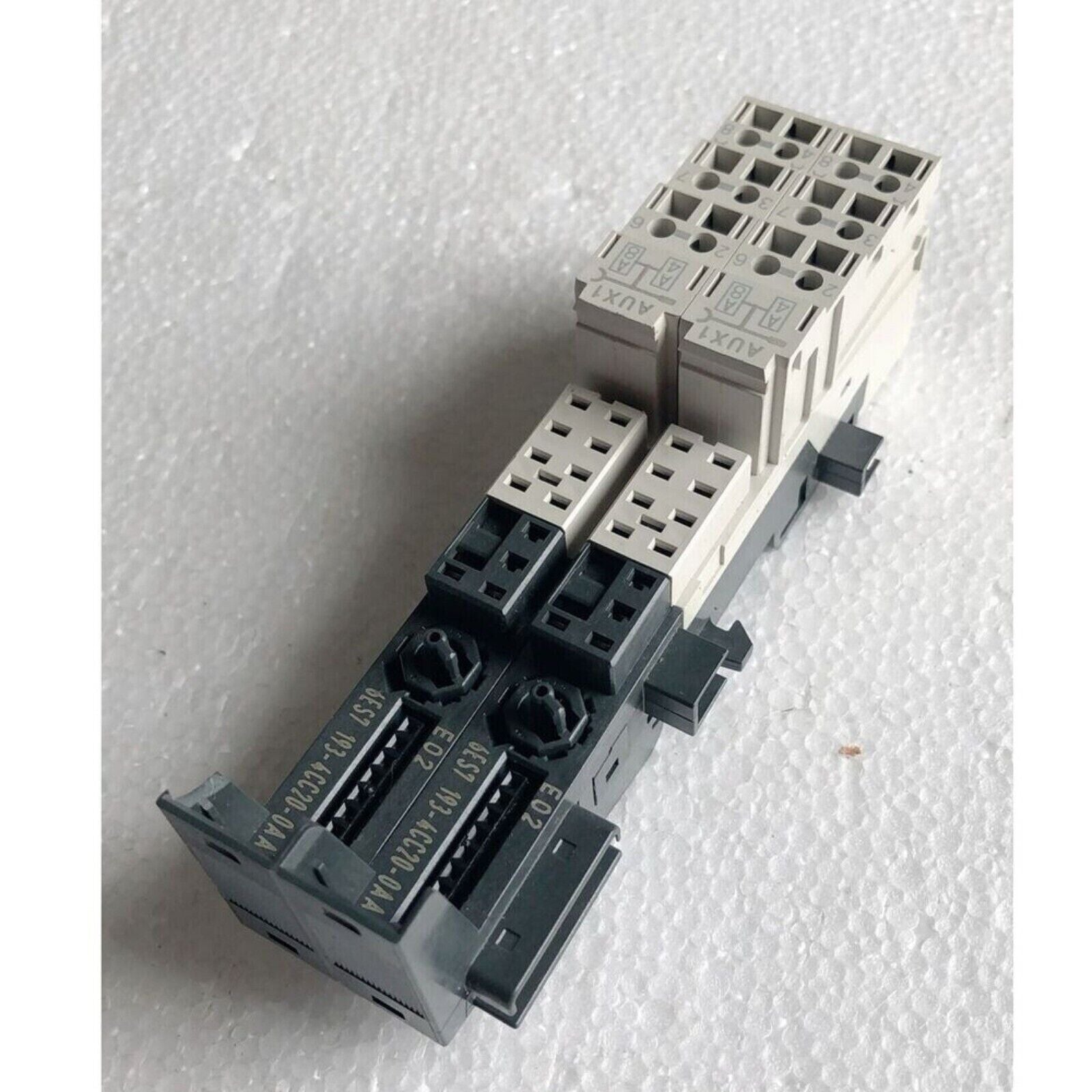 Siemens 6ES7 193-4CC20-0AA0 PLC terminal module. Black, gray, and beige plastic component. Industrial automation part.