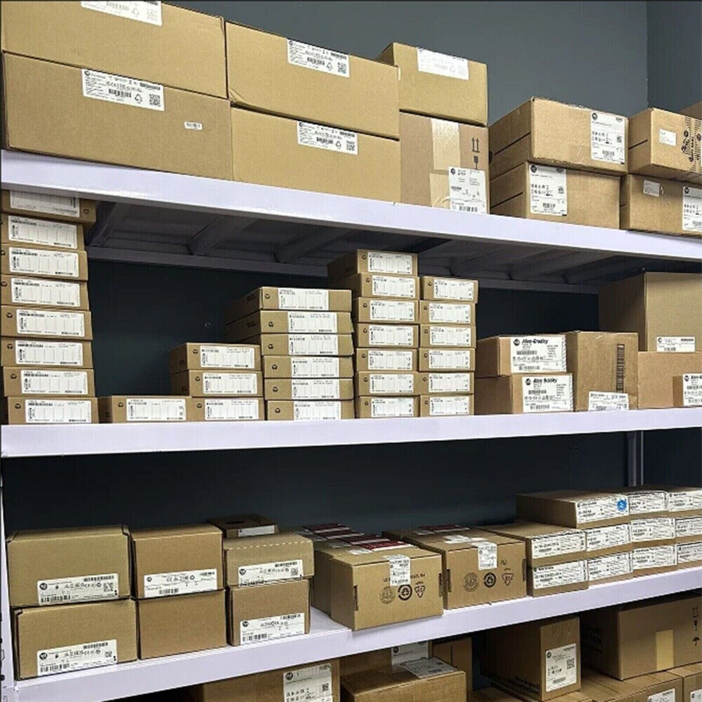 Siemens PLC modules in a warehouse, neatly stacked on shelves, ready for shipping