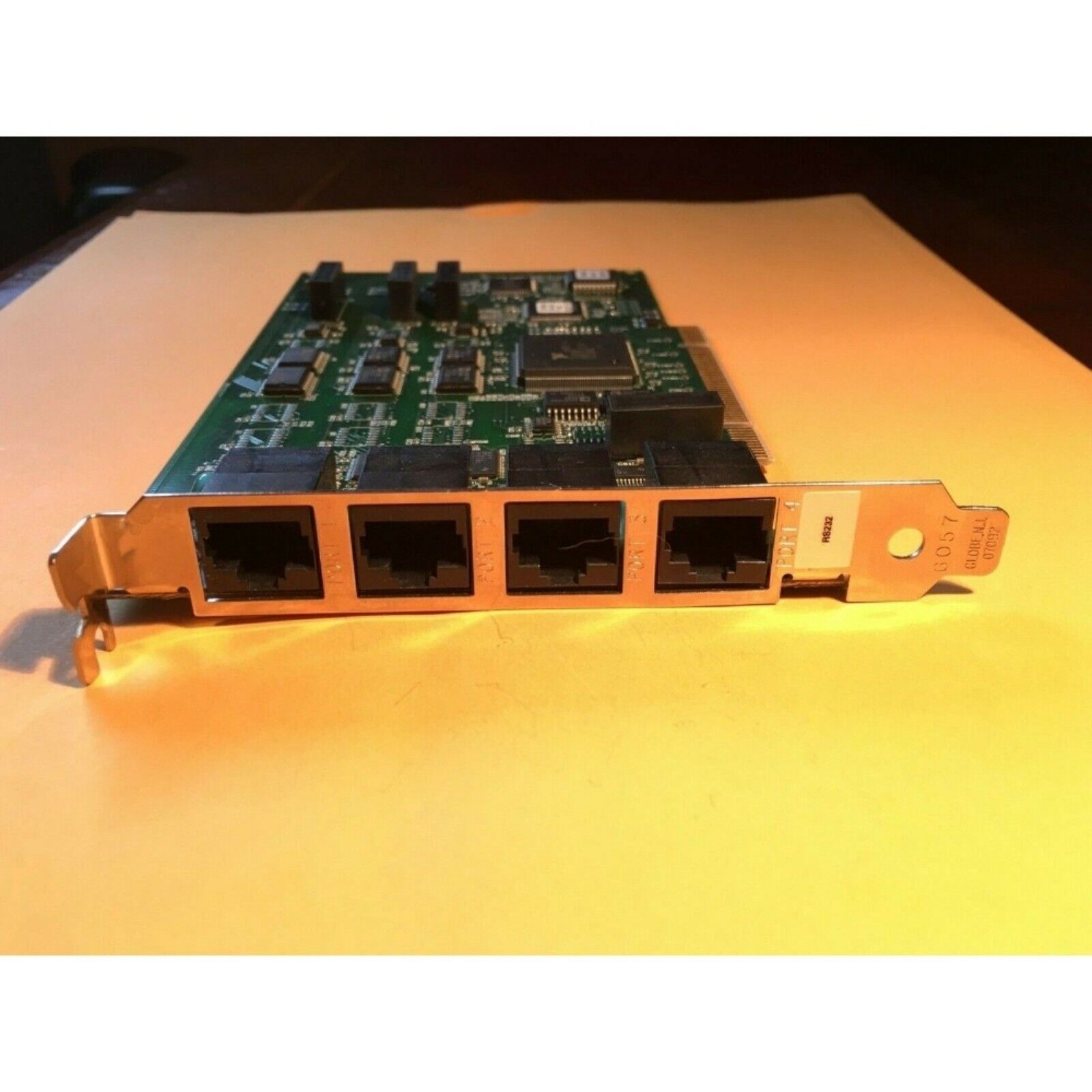 National Instruments PXI-8432/4 serial interface card with four RJ45 ports. Electronic circuit board.