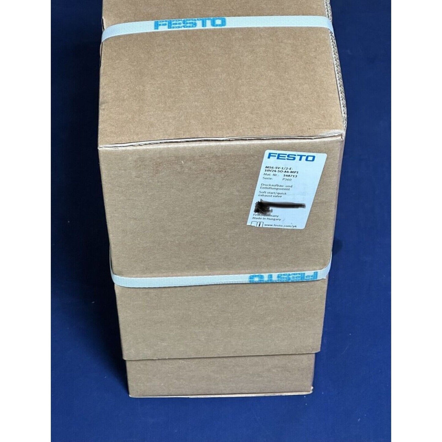 Festo MS6-SV-1/2-E-10v24-SO-A4-MP1 pneumatic valve in shipping box, product label, and branded tape.