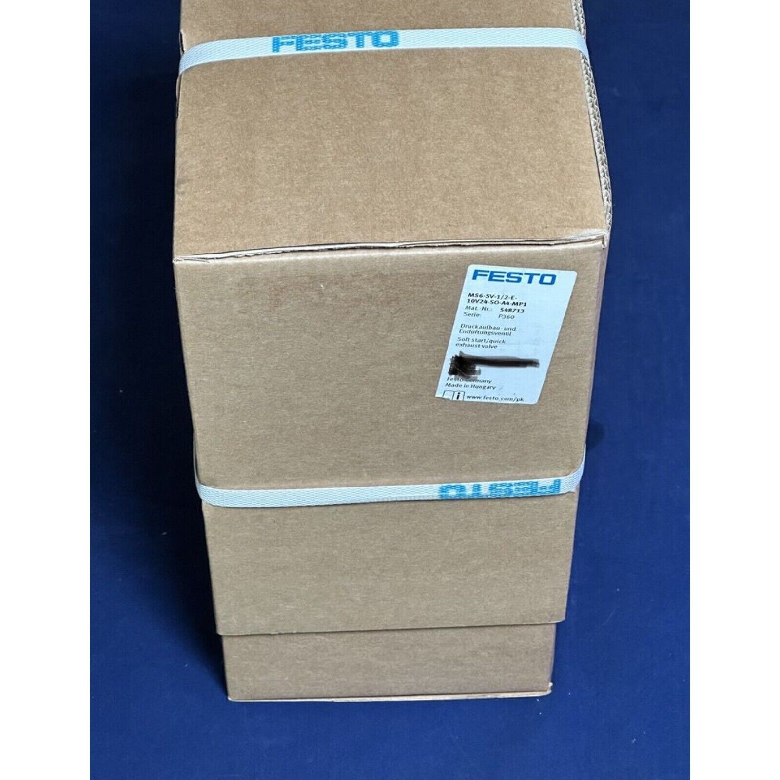 Festo MS6-SV-1/2-E-10v24-SO-A4-MP1 pneumatic valve in shipping box, product label, and branded tape.