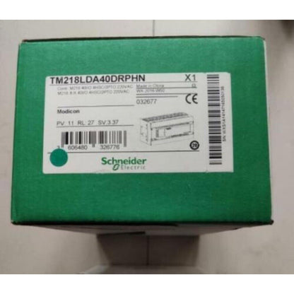 Schneider Electric TM218LDA40DRPHN PLC Module - New In Box, green box with product information.