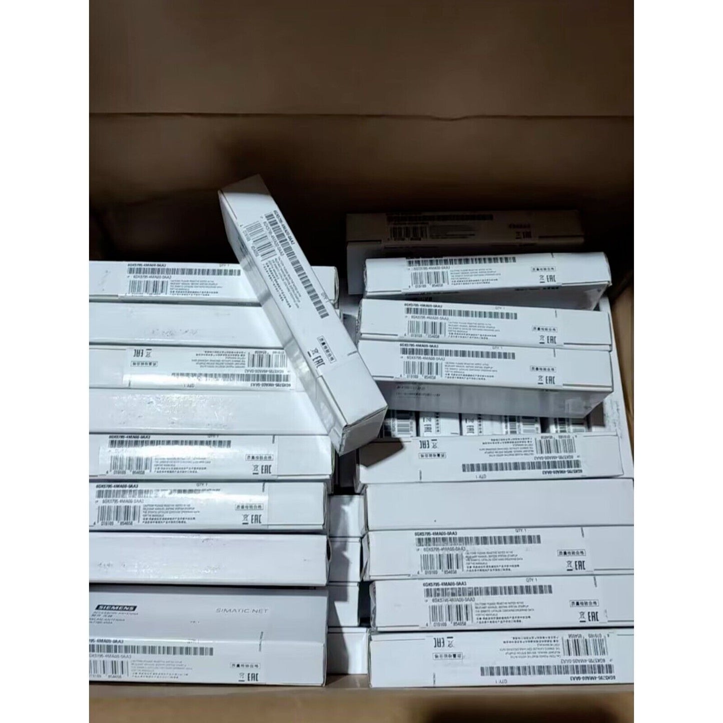Siemens ANT795-4MA IWLAN Antenna boxes in a warehouse, industrial automation parts.