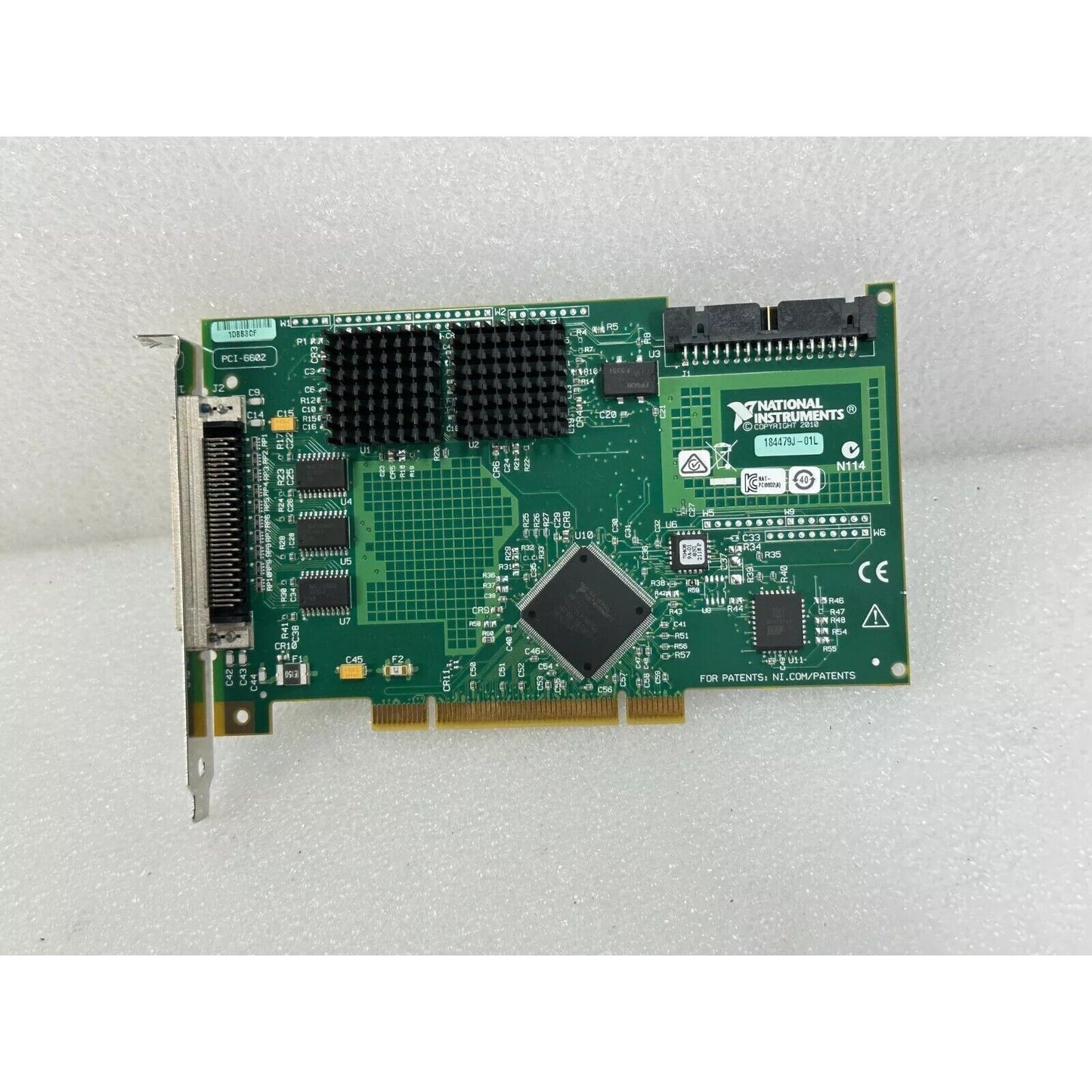 National Instruments PCI-6602 data acquisition card, green circuit board, black heatsink.